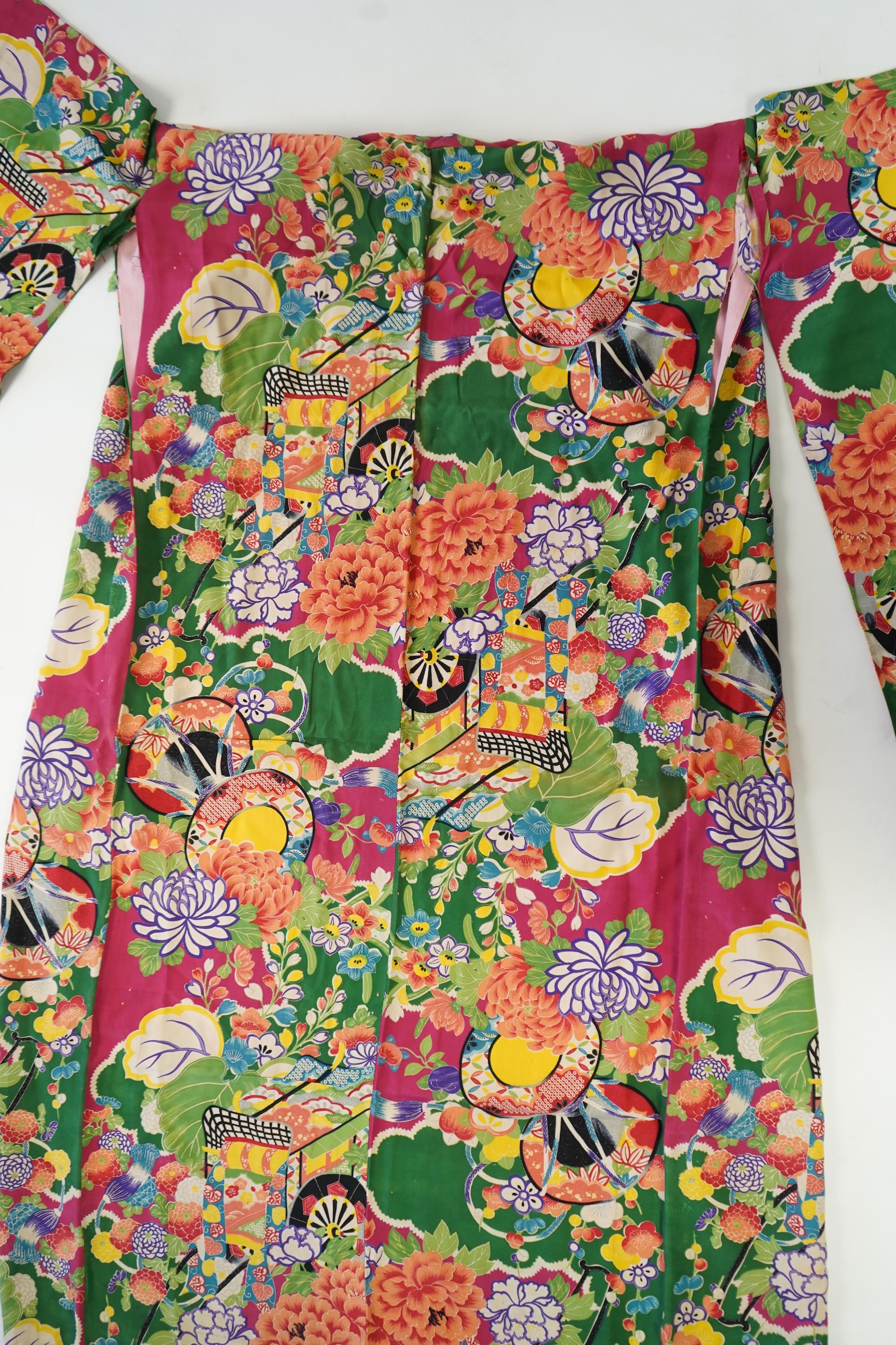 Four 1930’s - 1950’s printed silk full length silk lined Japanese kimonos. Two floral and two geometric in design. Longest black and orange floral designed kimono, 150cm long. Condition - purple and pink check kimono the